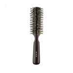 Japanese round hair brush made with soft natural bristles and a dark ebony wood handle, designed for gentle styling, smoothing, and adding shine.