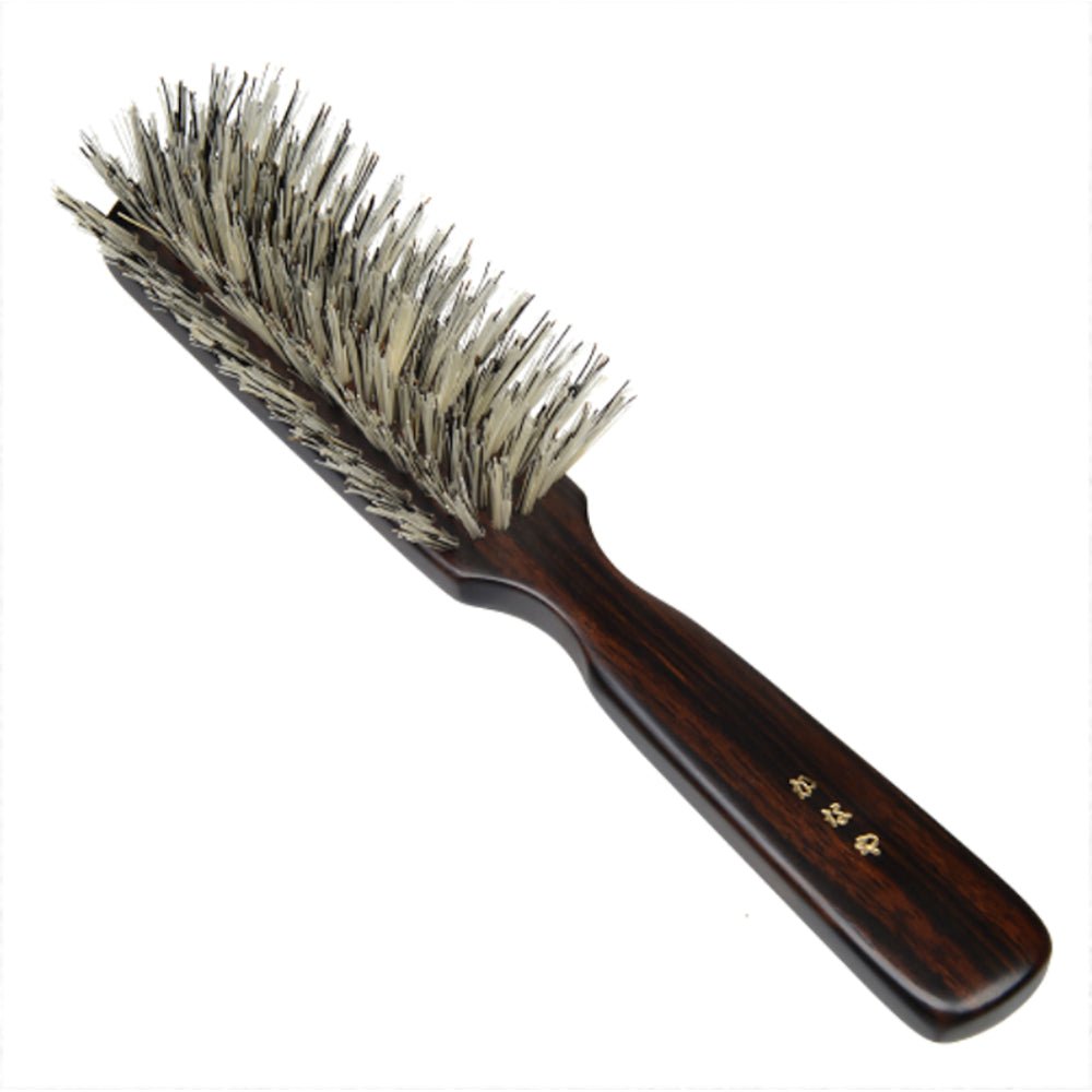Close-up of a Japanese soft natural bristle hair brush with a polished ebony wood handle and gold-etched kanji characters, ideal for smoothing and scalp care.
