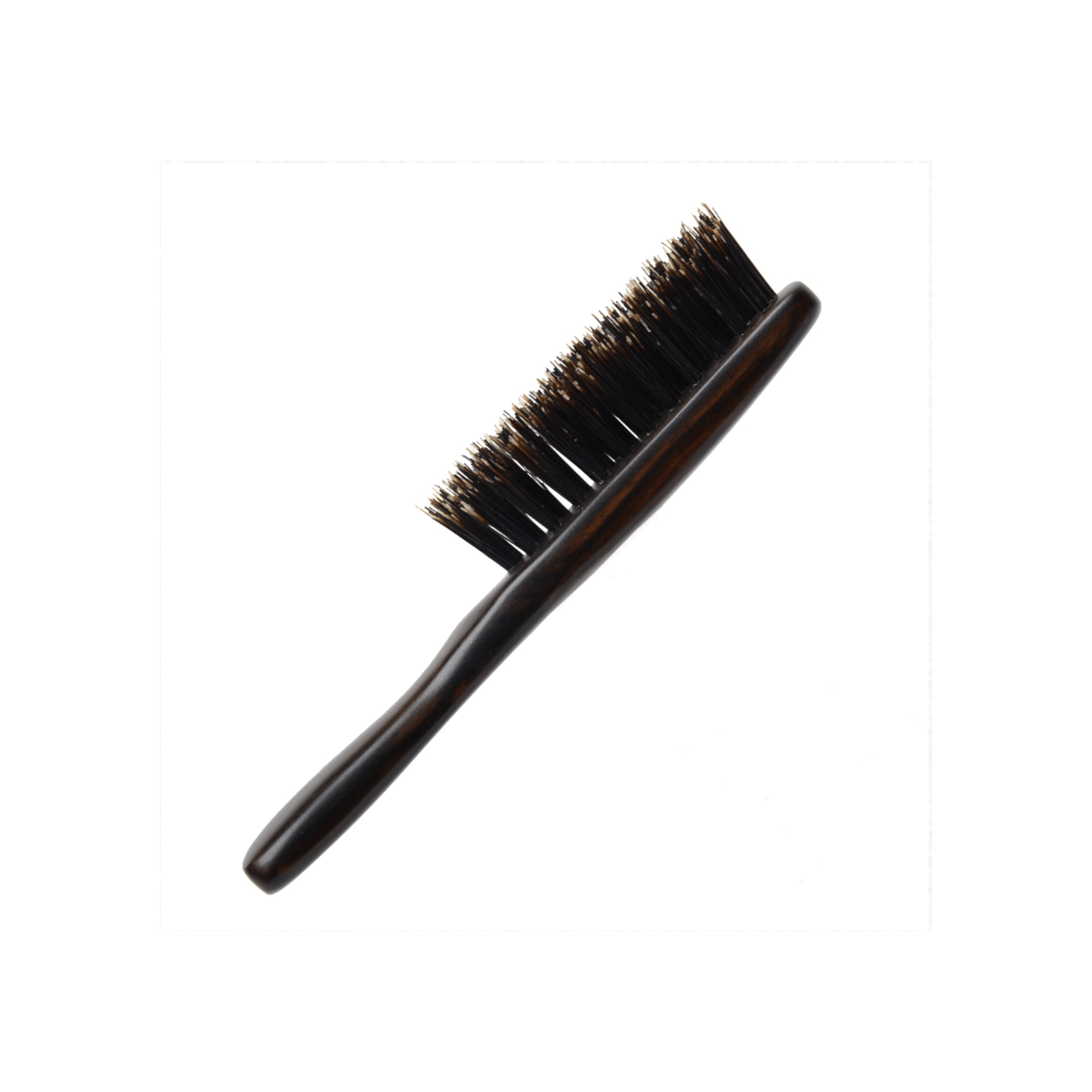 Side profile of the Kanaya wild boar bristle travel brush, showcasing its firm black bristles and curved dark wooden handle with a sleek, polished finish.