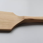 Close-up of the Sakura wood flat spatula showing the carved handle transition and natural wood grain