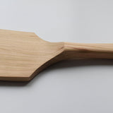 Close-up of the Sakura wood flat spatula showing the carved handle transition and natural wood grain