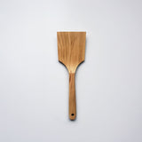 Sakura wood flat spatula with wide paddle shape and natural wood grain on a white background