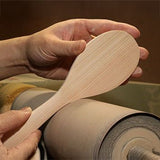 Sakura wood rice paddle being hand-finished to show the natural grain and smooth carved surface