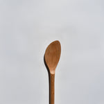 Close-up of the Sakura wood soup spatula showing the smooth carved bowl and natural wood grain