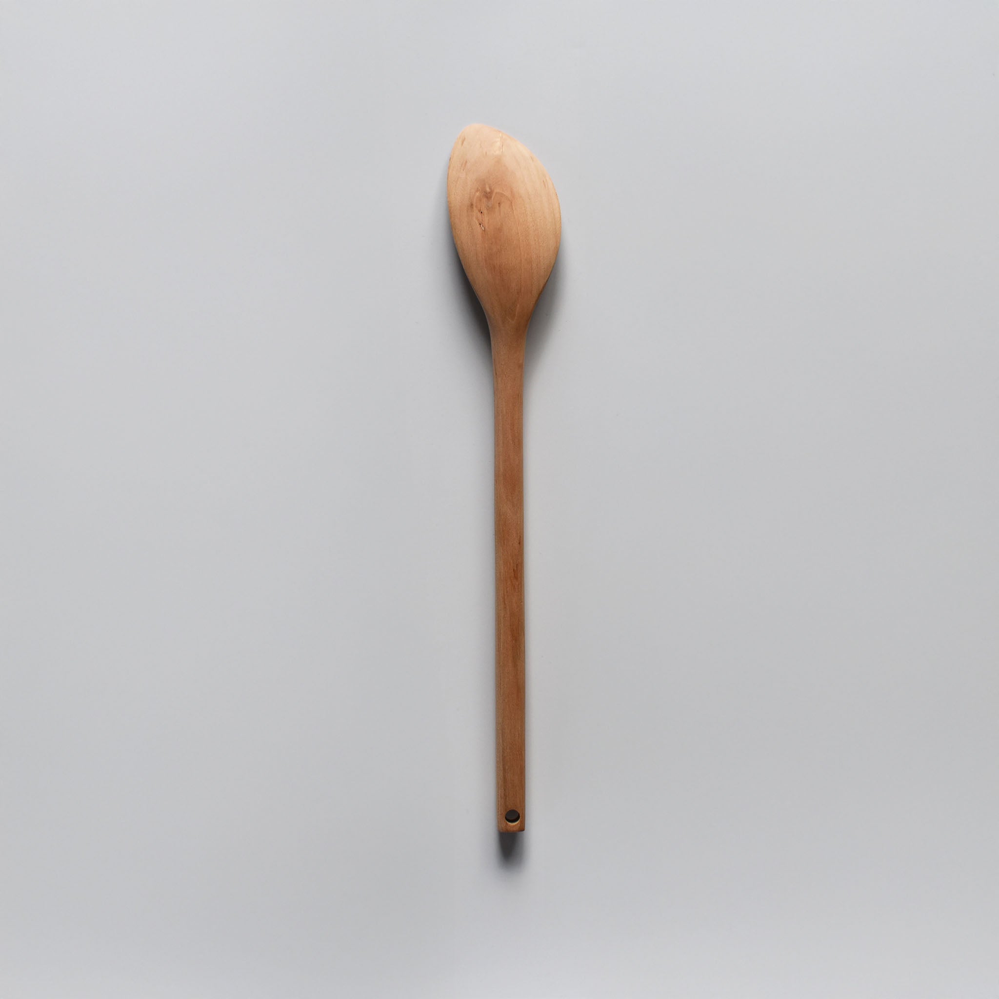 Sakura wood soup spatula with long handle and smooth carved spoon shape shown on a white background