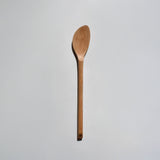 Sakura wood soup spatula with long handle and smooth carved spoon shape on a white background