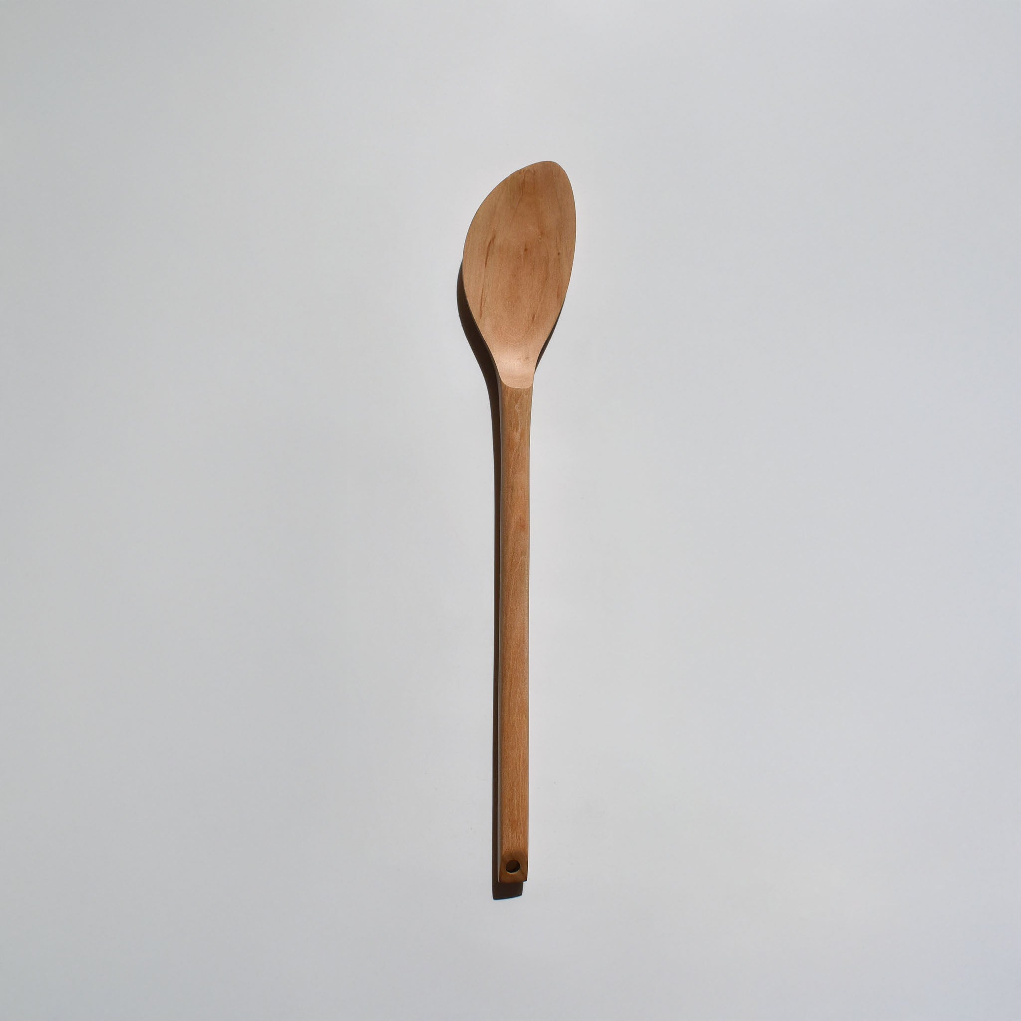 Sakura wood soup spatula with long handle and smooth carved spoon shape on a white background