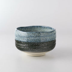 Seifu blue hand-glazed matcha bowl made in Mino, Japan. This ceramic chawan features rich gradients of blue and charcoal with a textured, wavy rim—perfect for traditional tea ceremony or as a statement serving piece.