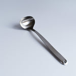 Full view of Sori Yanagi Stainless Steel Ladle showcasing its minimalist curved handle and polished ladle head.