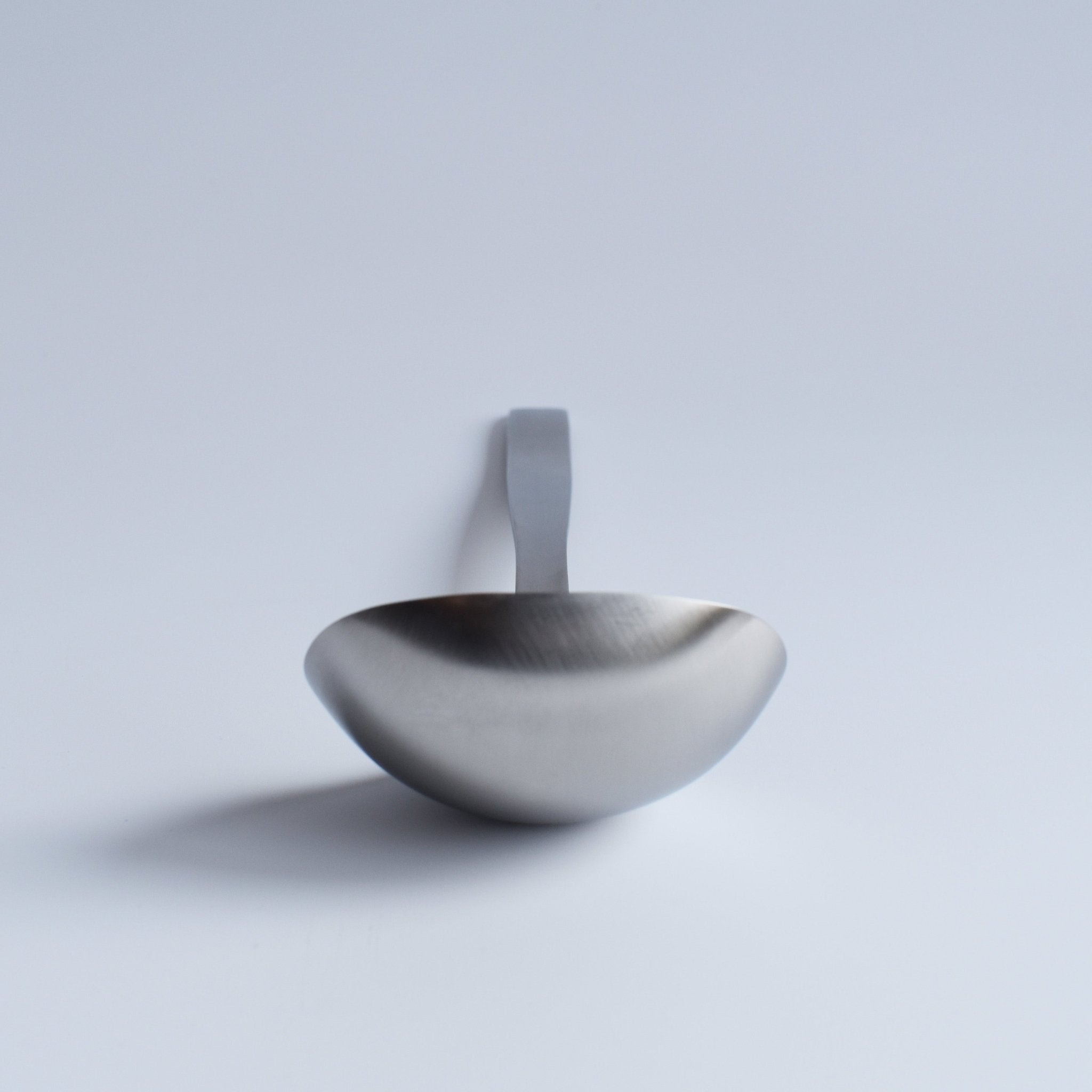 Front view of Sori Yanagi Stainless Steel Ladle showing deep, smooth bowl — minimalist Japanese kitchen design.