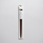 Plum wood chopsticks in minimalist white packaging with floral illustration