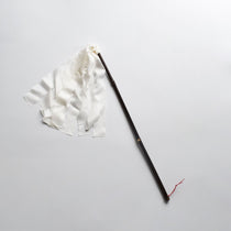 Japanese silk duster with white silk strips attached to a dark bamboo handle, used for delicate dusting and ritual cleaning.