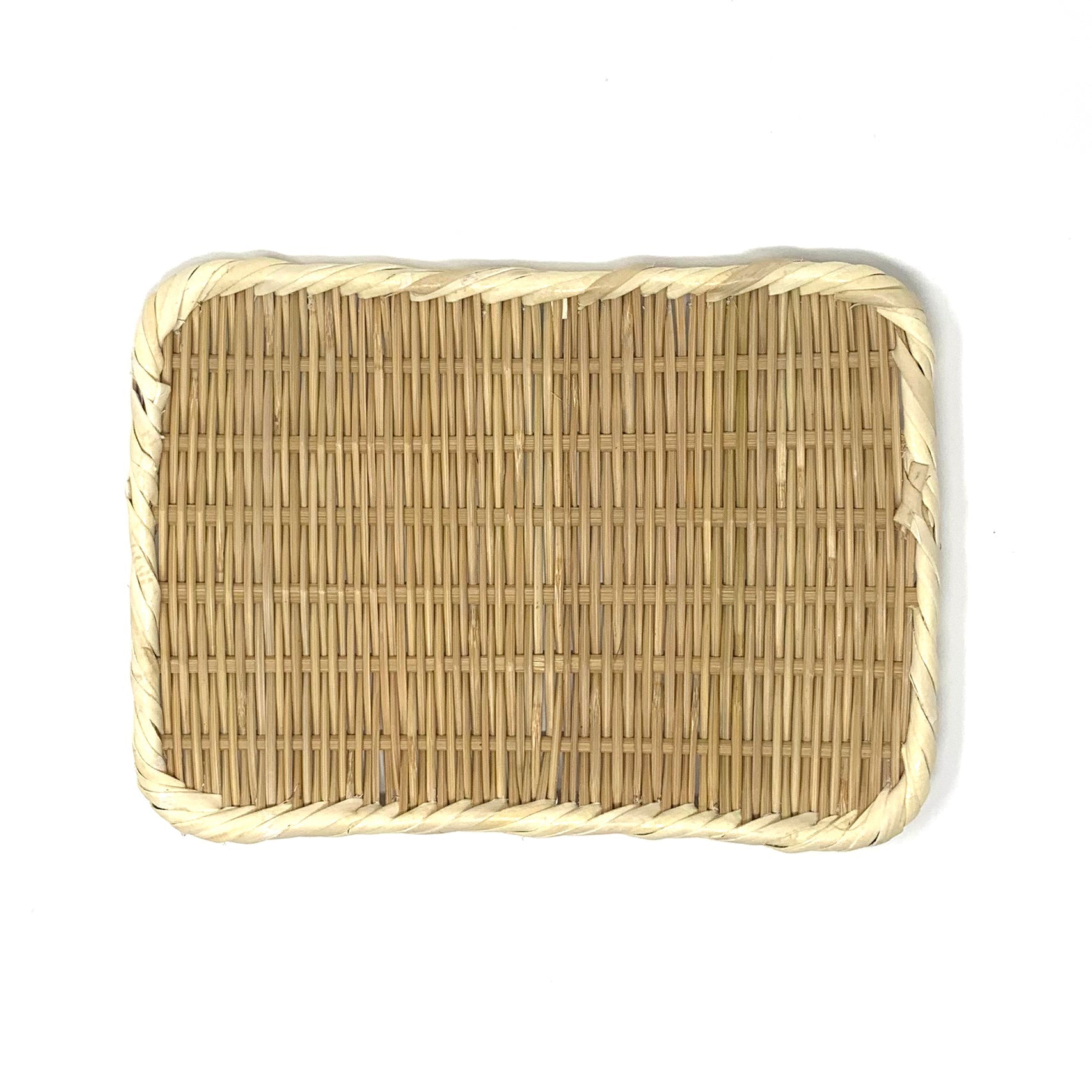 Rectangular handwoven bamboo tray with rounded corners and braided rim, crafted from natural materials.
