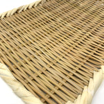 Angled close-up of a handwoven rectangular bamboo zaru colander with a twisted rim, showcasing the fine basket weave and natural fiber texture on a white background