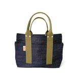 Studio photo of small Japanese selvage denim tote with olive green handles, side pockets, and front stitch detailing by Thread Line Tokyo