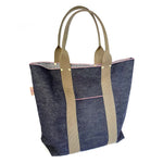 Studio shot of Japanese selvage denim tote bag with olive green handles, gold rivets, and outer pocket, made by Thread Line Tokyo