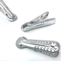 Set of three Japanese aluminum clothes pegs featuring a decorative wave cutout design, ideal for hanging laundry or multipurpose household use