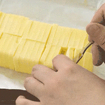 Looping gif showing a 5g slice being lifted from a pre-cut butter block using the Japanese butter slicer—ideal for precise portioning.