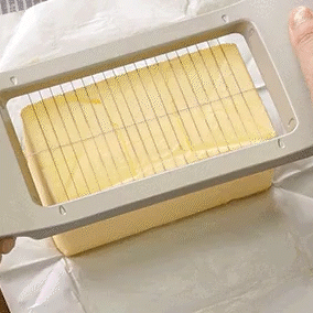 Looping gif showing Japanese butter slicer making clean, even slices from a full block of butter with minimal effort.