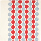 Flat lay of Yumeji Takehisa’s Tsunagi Dango furoshiki cloth featuring repeating red and grey dango pattern on a cream background, traditional Japanese textile design.