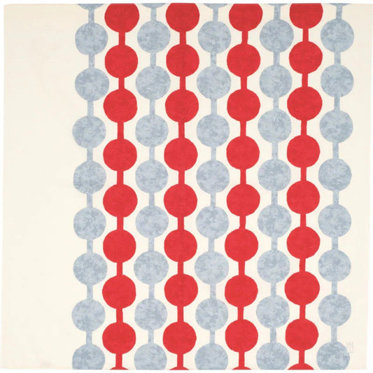 Flat lay of Yumeji Takehisa’s Tsunagi Dango furoshiki cloth featuring repeating red and grey dango pattern on a cream background, traditional Japanese textile design.