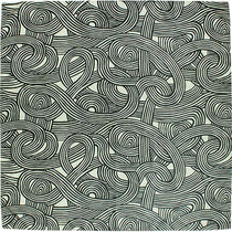 A close-up image of a furoshiki cloth laid flat, showcasing the intricate “knot” design from the ISA-MONYO series in khaki. The abstract pattern features interwoven loops and curved lines resembling tangled cords, drawn in black against a light greenish-beige background. The repetitive swirling motif gives a sense of movement and depth, reflecting a blend of traditional Japanese aesthetics and modern graphic design.