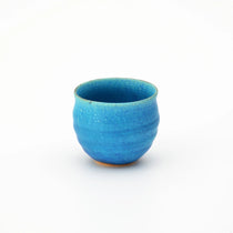 Handcrafted Shigaraki rocks glass with vibrant azure blue glaze and organic curves, perfect for serving tea or whiskey.