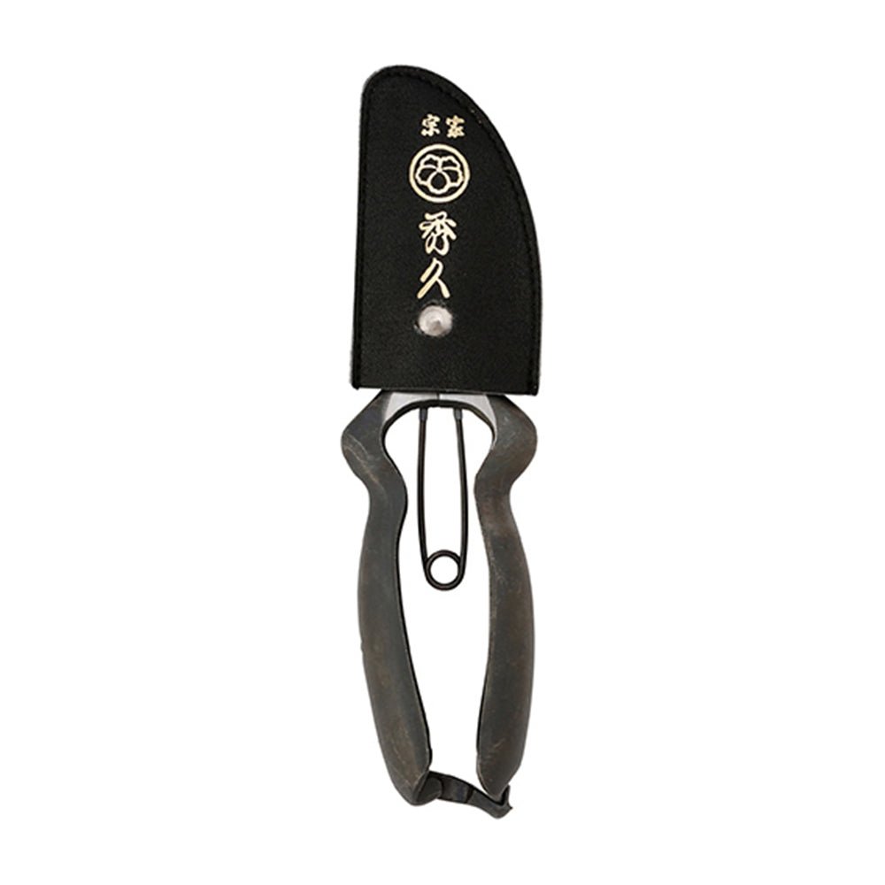 Japanese garden pruners with weathered forged steel handles and black protective sheath featuring gold kanji characters, showcasing traditional craftsmanship and tool preservation. 