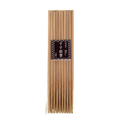 Set of natural bamboo chopsticks in plastic packaging with a dark brown Japanese label. 