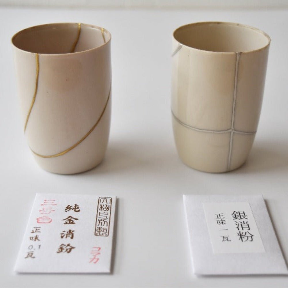 Side-by-side comparison of Kintsugi-repaired cups using gold and silver powder finishes, demonstrating different aesthetic options from the Japanese repair kit.