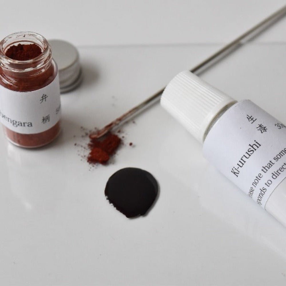 Close-up of Kintsugi repair tools with raw Ki-urushi lacquer and bengara red pigment, part of an authentic Japanese pottery repair kit.
