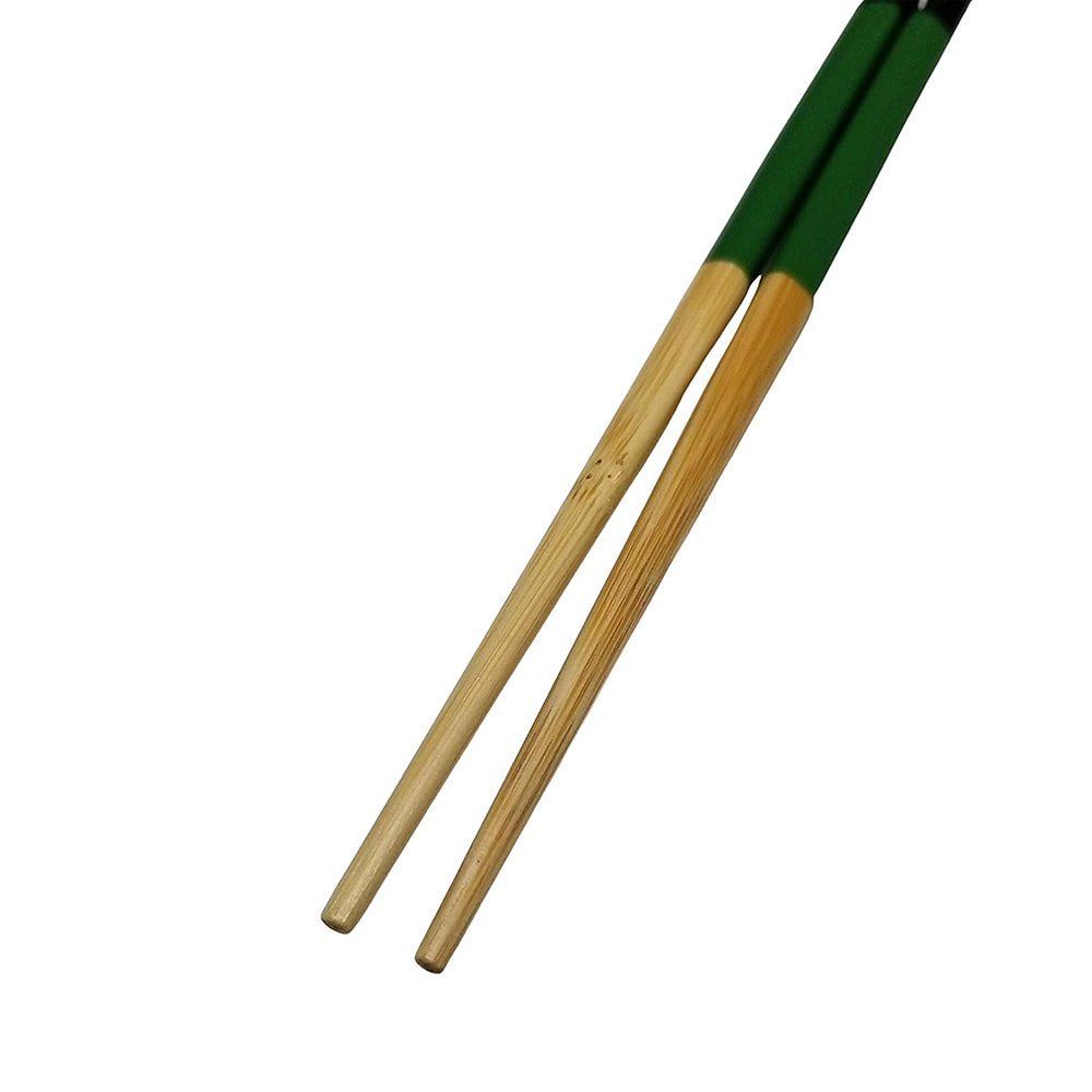 Close-up view of the tapered bamboo tips on a pair of long green-handled chopsticks.