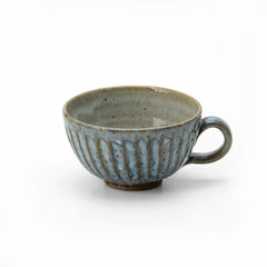 Seihagi artisan mug with blue-green glaze and hand-carved vertical ridges, showcasing Japanese craftsmanship and wabi-sabi aesthetics—ideal for tea, coffee, or display. 