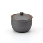 Dark charcoal Shigaraki ceramic salt jar with lid, handcrafted in Japan with a rustic matte finish, ideal for storing salt or spices in the kitchen.