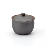 Dark charcoal Shigaraki ceramic salt jar with lid, handcrafted in Japan with a rustic matte finish, ideal for storing salt or spices in the kitchen.