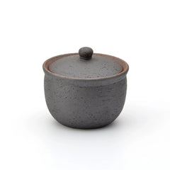 Dark charcoal Shigaraki ceramic salt jar with lid, handcrafted in Japan with a rustic matte finish, ideal for storing salt or spices in the kitchen.