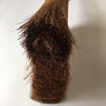Close-up of Shuro palm fiber broom head wrapped in copper wire, showing intricate craftsmanship and natural texture.