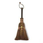 Compact Japanese shuro whisk broom in small size, featuring a dark wooden handle, copper wire binding, and brass fastener, ideal for desktop or narrow surface cleaning.